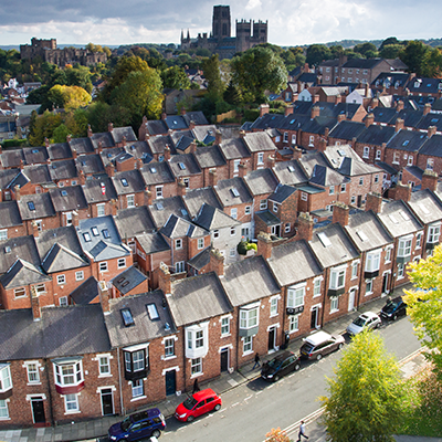 Terraced homes with on-street parking in London.
